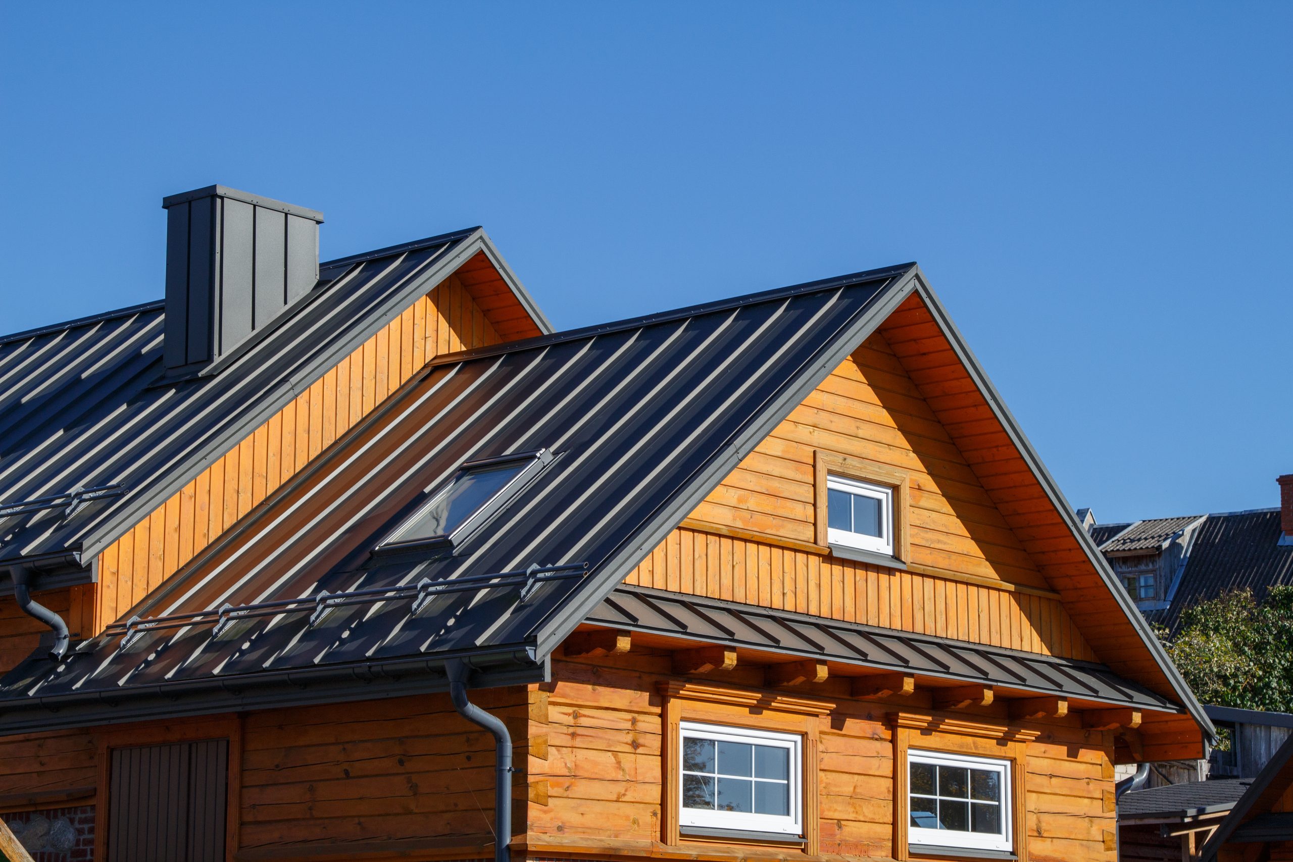 Wooden house with classic metal roof.